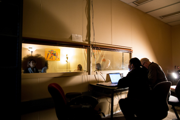 researchers observing study through window