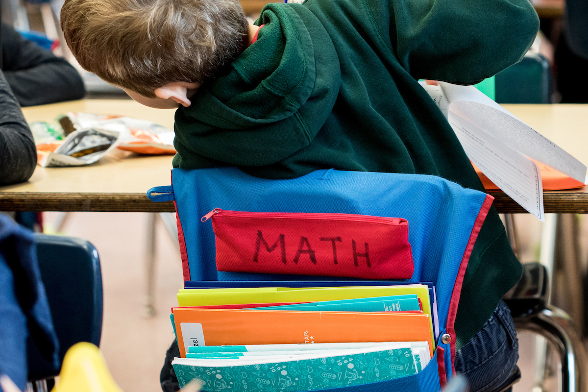 back of a child in a classroom